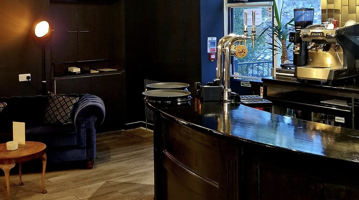 Wall-mounted air conditioning unit installed above a window in a Sheffield bar by Cooling and Heating Space